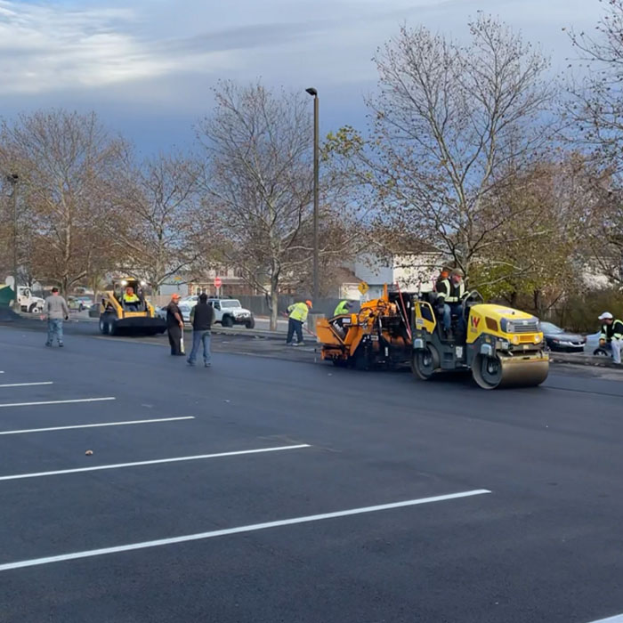 Group of workers fixing parking lot
